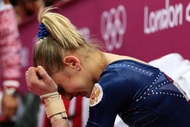 LONDON, ENGLAND - AUGUST 02: Victoria Komova of Russia reacts after finishing in second and winning the silver medal in the Artistic Gymnastics Women's Individual All-Around final on Day 6 of the London 2012 Olympic Games at North Greenwich Arena on August 2, 2012 in London, England. (Photo by Ronald Martinez/Getty Images)