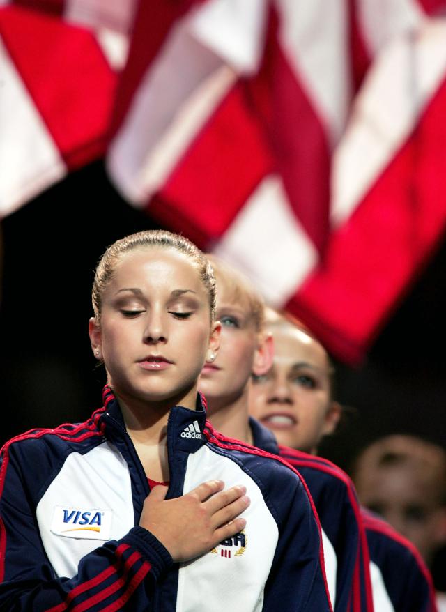 ANAHEIM, CA - JUNE 25: Carly Patterson closes her eyes during the national anthem before the Women's preliminaries of the U.S. Gymnastics Olympic Team Trials on June 25, 2004 at The Arrowhead Pond of Anaheim in Anaheim, California. (Photo by Donald Miralle/Getty Images)