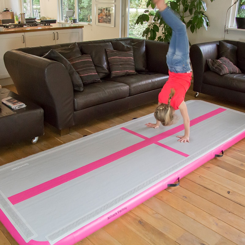 Gymnast doing handstand at home on air track mat. Source: airtrackus.com