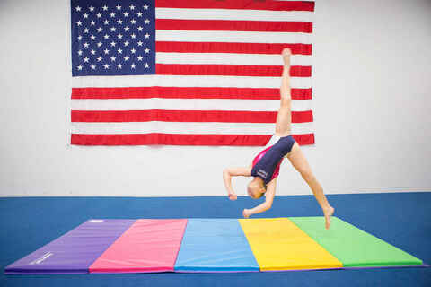 Gymnast on tumbling mat