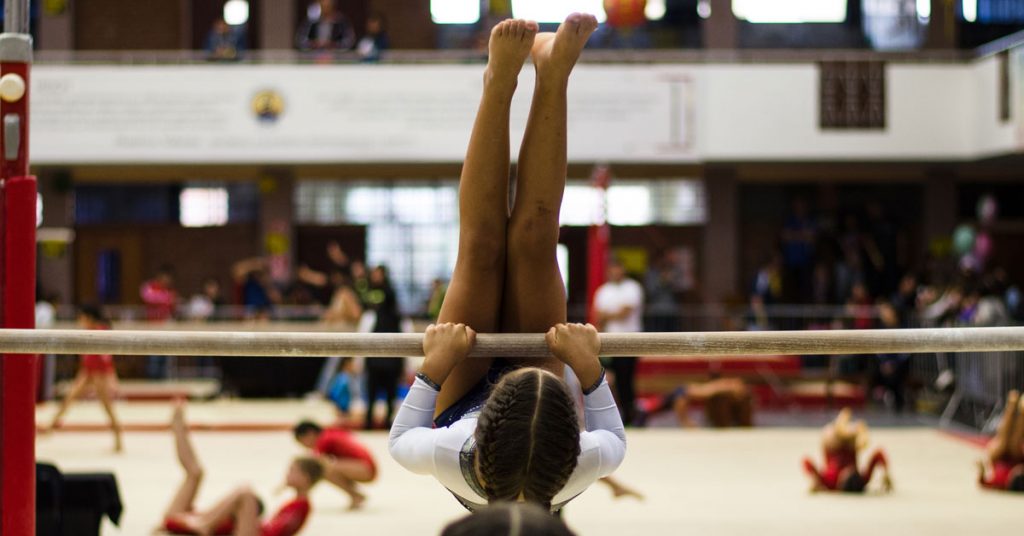 Gymnast practicing on bar