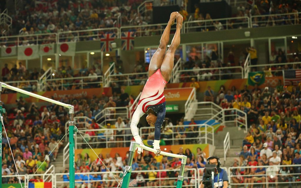 Olympic champion Simone Biles of United States competes on the uneven bars at women's team all-around gymnastics at Rio 2016 Olympic Games at Rio Olympic Arena